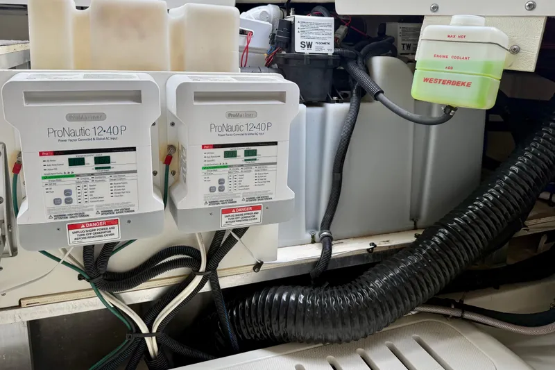 Slide: The Image of Engine compartment of 2022 Sea Ray Sundancer 320 Outboard with ProNautic chargers and coolant tank. - 80