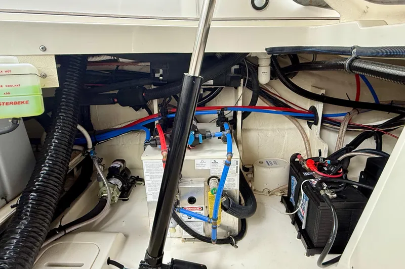 Slide: The Image of Engine compartment of 2022 Sea Ray Sundancer 320 Outboard with visible wiring and components. - 83