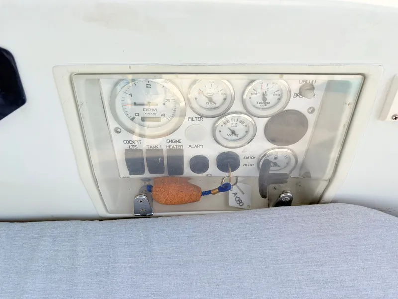 Slide: The Image of Covered equipment on a 1990 Beneteau 38 sailboat, docked in a marina. - 10