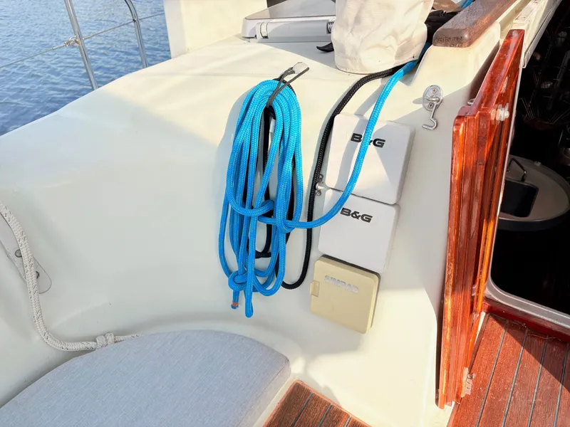 Slide: The Image of Beneteau 38 (1990) boat detail showing a stainless steel vent and wooden deck accent. - 13