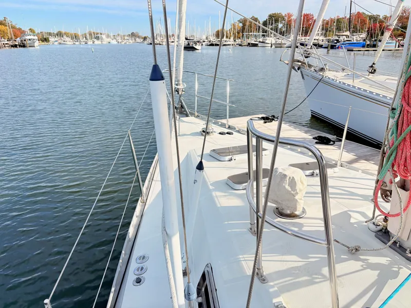 Slide: The Image of Sailboat deck view of a 1990 Beneteau 38 in a marina setting. - 18
