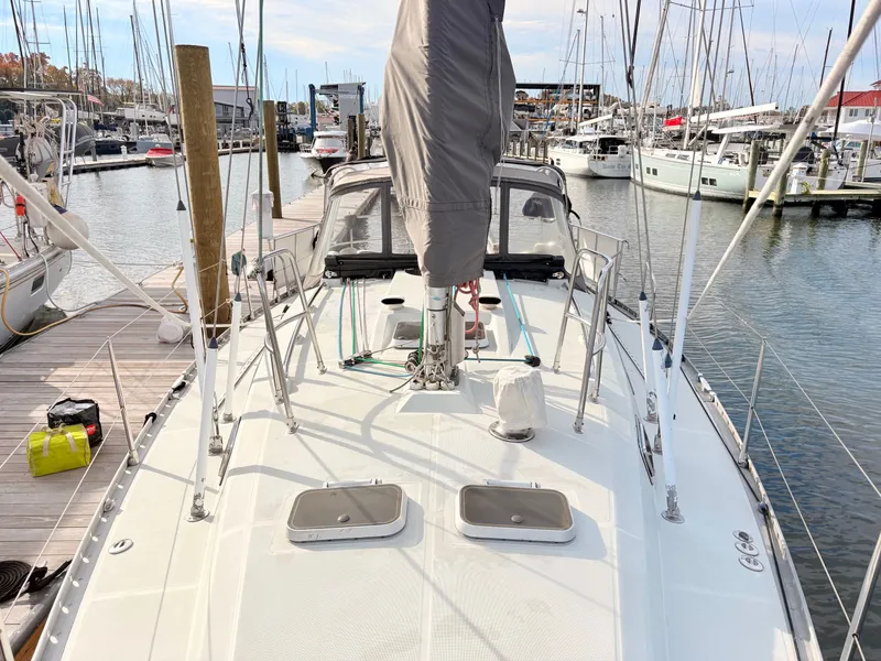Slide: The Image of Sailboat deck view of 1990 Beneteau 38 docked in a marina. - 20