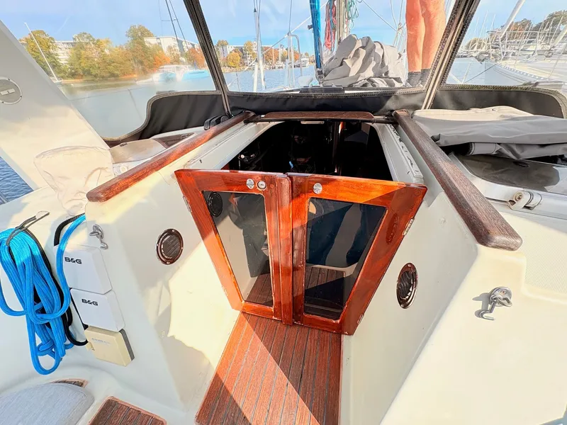 Slide: The Image of Sailboat docked at marina, Beneteau 38, 1990 model, with covered mast and clear sky. - 23