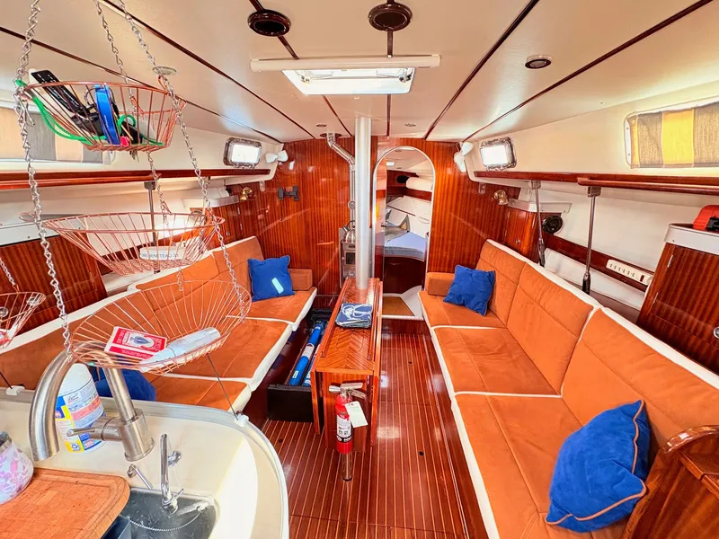 Slide: The Image of Beneteau 38 sailboat with solar panels docked at a marina, 1990 model. - 24