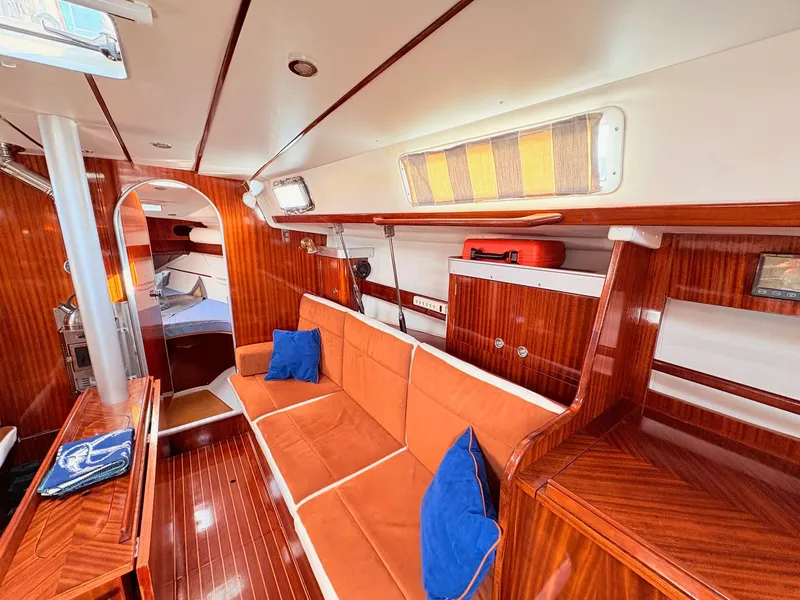 Slide: The Image of Interior of a 1990 Beneteau 38 yacht with wood finish and cozy seating. - 27