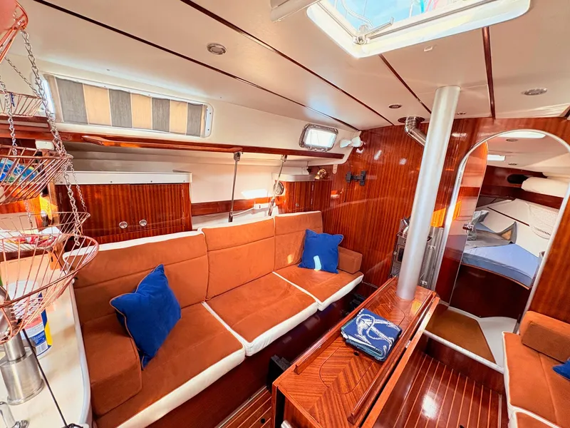 Slide: The Image of Interior of 1990 Beneteau 38 sailboat with navigation panel and wooden finish. - 28