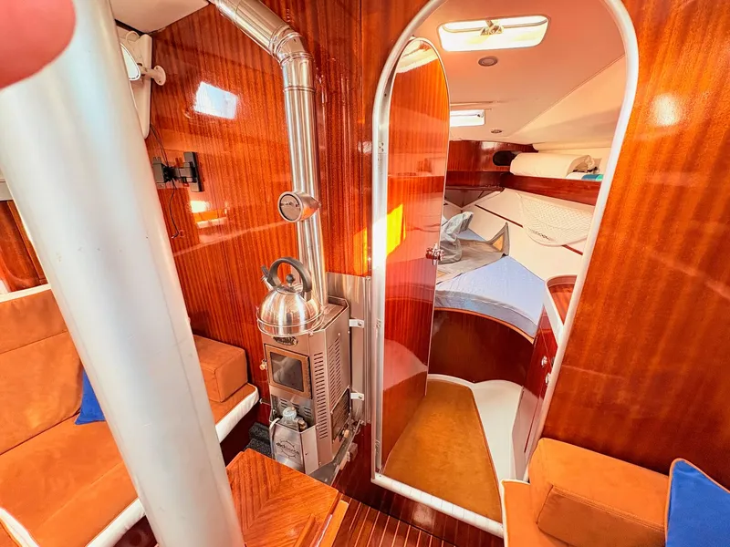 Slide: The Image of Luxurious interior of a 1990 Beneteau 38 sailboat with plush seating and wooden finishes. - 30