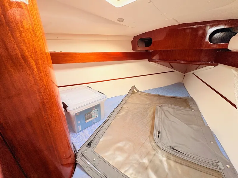 Slide: The Image of Interior of 1990 Beneteau 38 sailboat with wood finish and cozy seating area. - 32