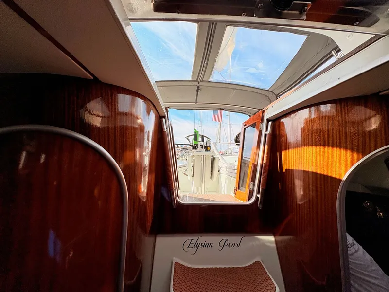 Slide: The Image of Cozy cabin interior of 1990 Beneteau 38 sailboat with wooden cabinetry and bed. - 37