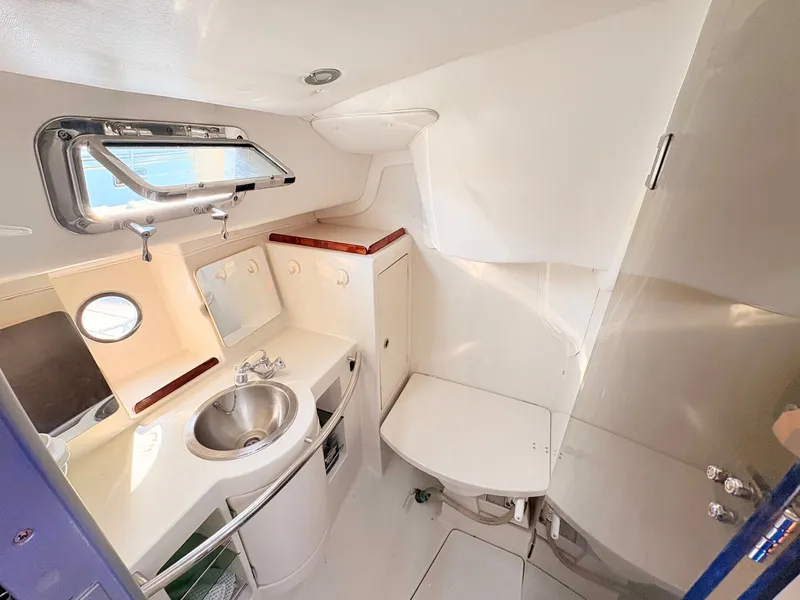 Slide: The Image of Compact bathroom in a 1990 Beneteau 38 yacht, featuring a toilet and sink. - 38