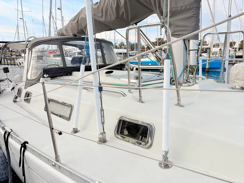 Slide: The Image of Cockpit view of a 1990 Beneteau 38 sailboat on open water, featuring navigation equipment. - 4
