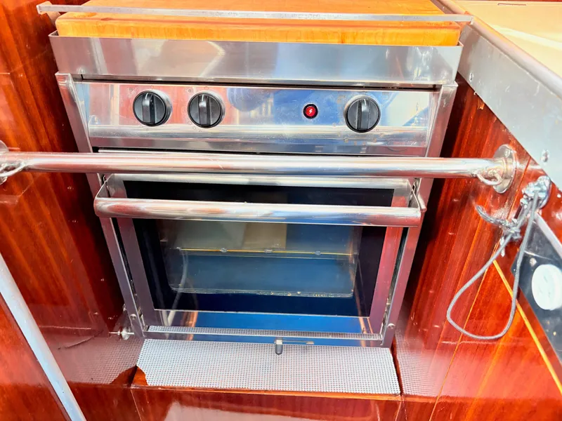 Slide: The Image of Interior of 1990 Beneteau 38 yacht bathroom with sink, mirror, and porthole window. - 40