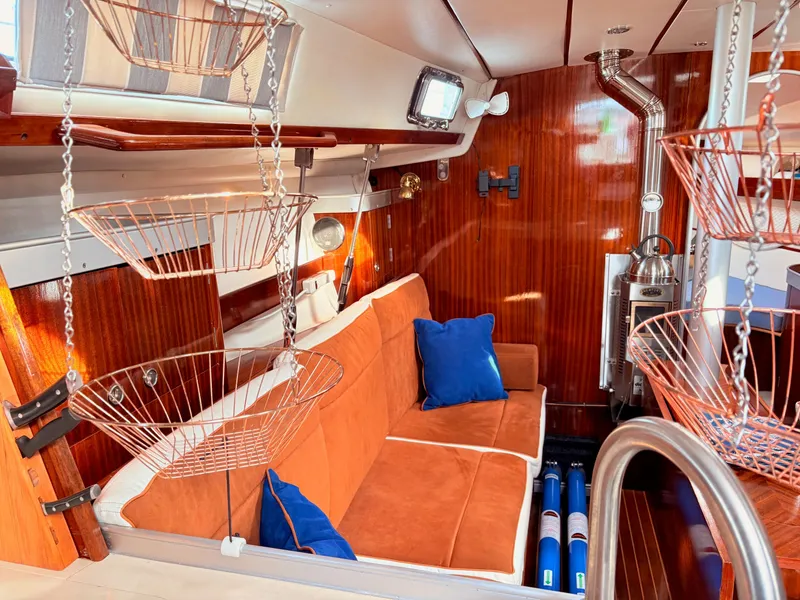 Slide: The Image of Microwave in 1990 Beneteau 38 yacht kitchen with wooden cabinetry and porthole window. - 43