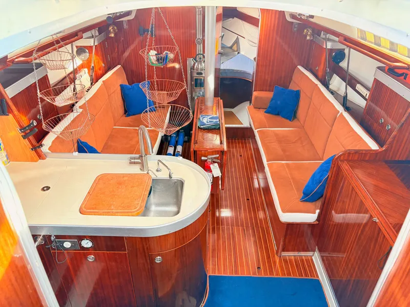 Slide: The Image of Interior of a 1990 Beneteau 38 sailboat with wooden cabinetry and knife storage. - 44