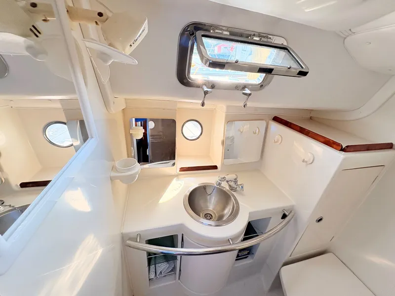 Slide: The Image of Interior of 1990 Beneteau 38 sailboat with cozy seating and wooden finishes. - 45
