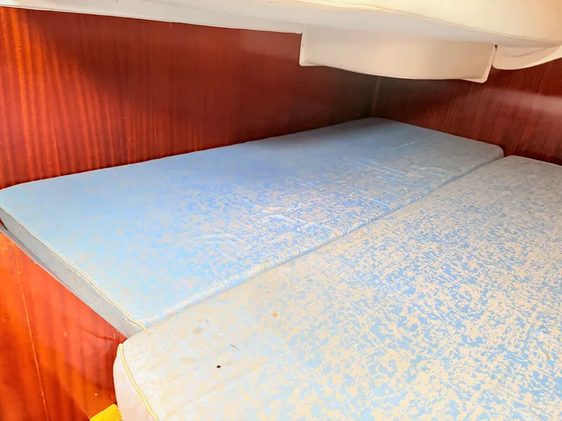 Slide: The Image of Interior of 1990 Beneteau 38 yacht bathroom with sink, mirror, and porthole window. - 47