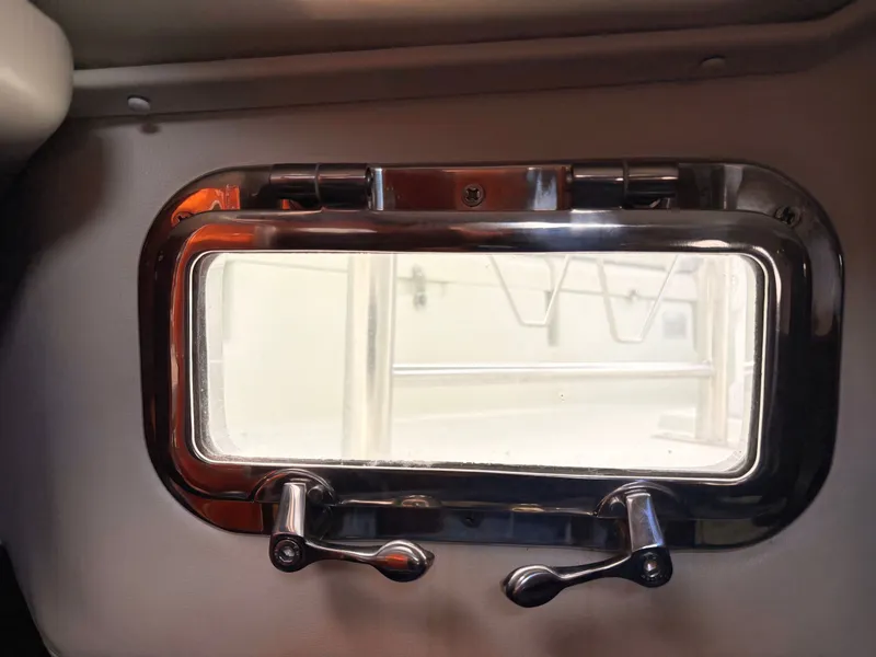 Slide: The Image of Cozy cabin interior of a 1990 Beneteau 38 sailboat with blue bedding and wooden accents. - 48