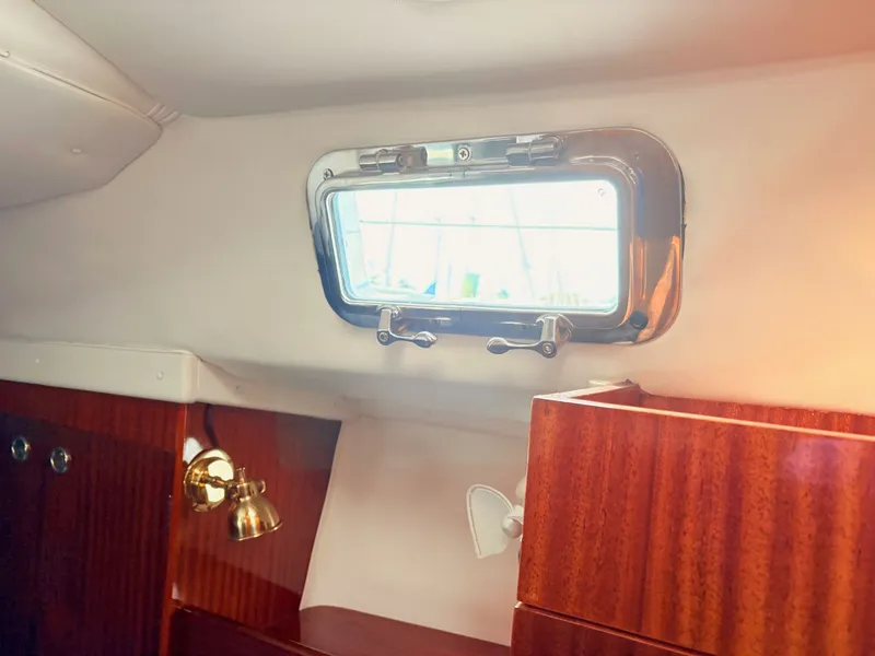 Slide: The Image of Interior cabin bed of 1990 Beneteau 38 sailboat with blue cushions. - 49