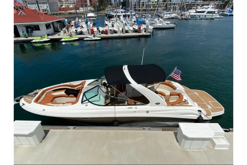 Slide: The Image of 2008 Sea Ray 290 SLX boat docked at marina with American flag. - 4