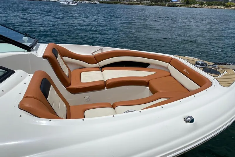 Slide: The Image of 2008 Sea Ray 290 SLX boat with tan and white seating on the water. - 5
