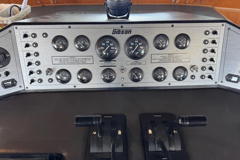 Slide: The Image of Control panel of a 1993 Gibson 44 Cabin Yacht with gauges and switches. - 12