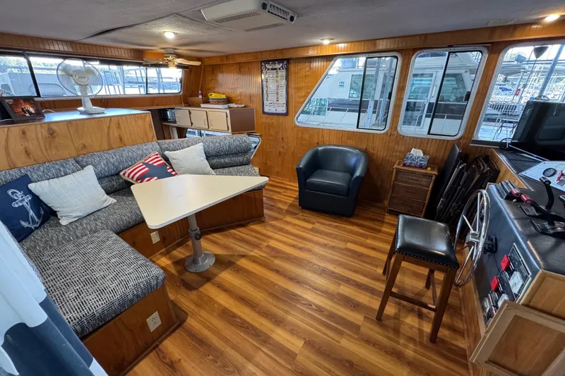 Slide: The Image of Cozy interior of 1993 Gibson 44 Cabin Yacht with wood paneling and seating area. - 9