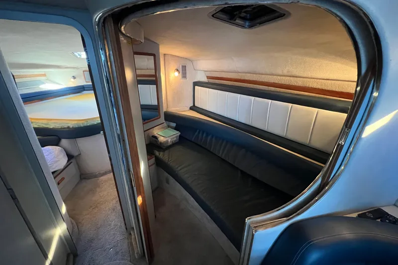 Slide: The Image of Interior of a 1991 Sea Ray 400 Express Cruiser, featuring a cozy cabin with seating and sleeping area. - 12