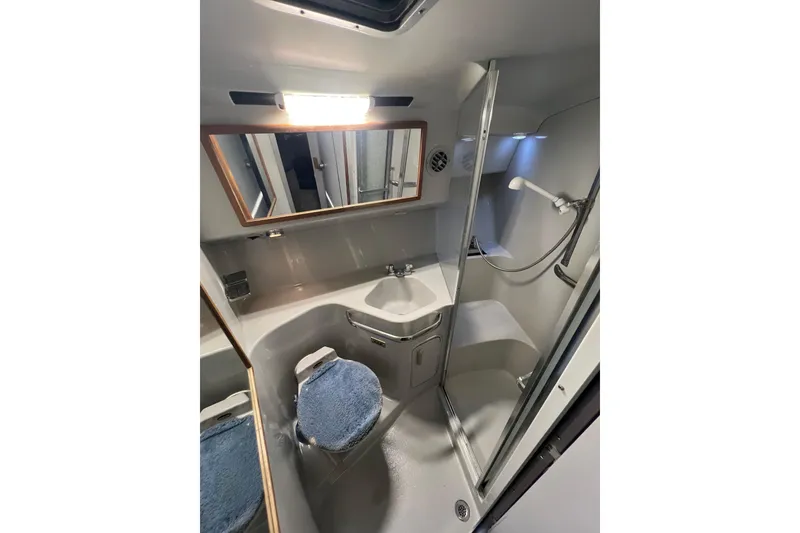 Slide: The Image of Bathroom interior of 1991 Sea Ray 400 Express Cruiser with shower and sink. - 13