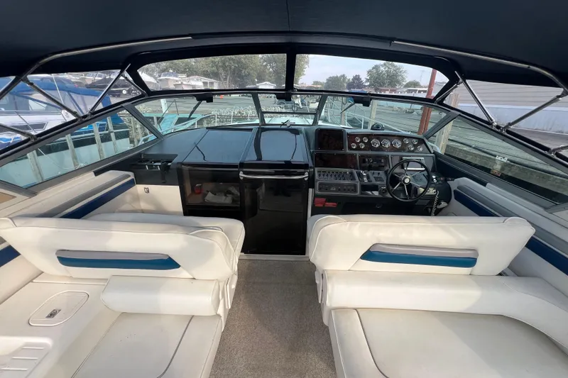 Slide: The Image of 1991 Sea Ray 400 Express Cruiser cockpit with white seating and control panel. - 5