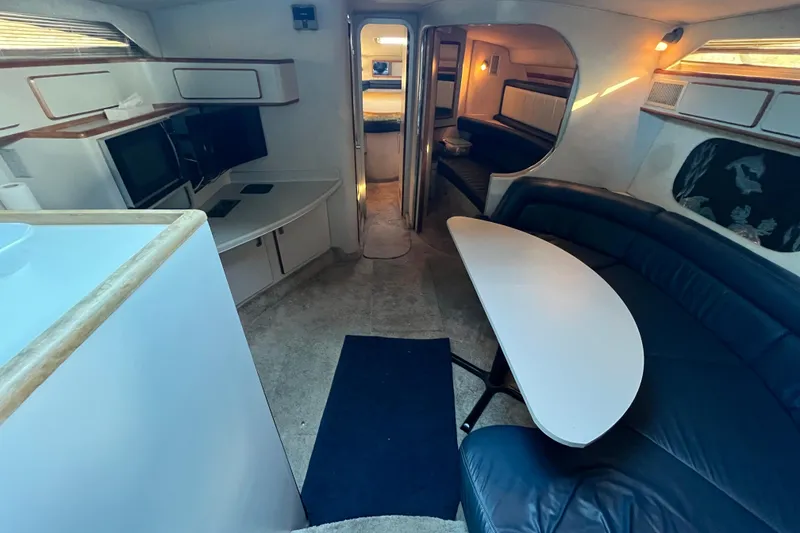 Slide: The Image of Interior of 1991 Sea Ray 400 Express Cruiser with modern seating and dining area. - 9