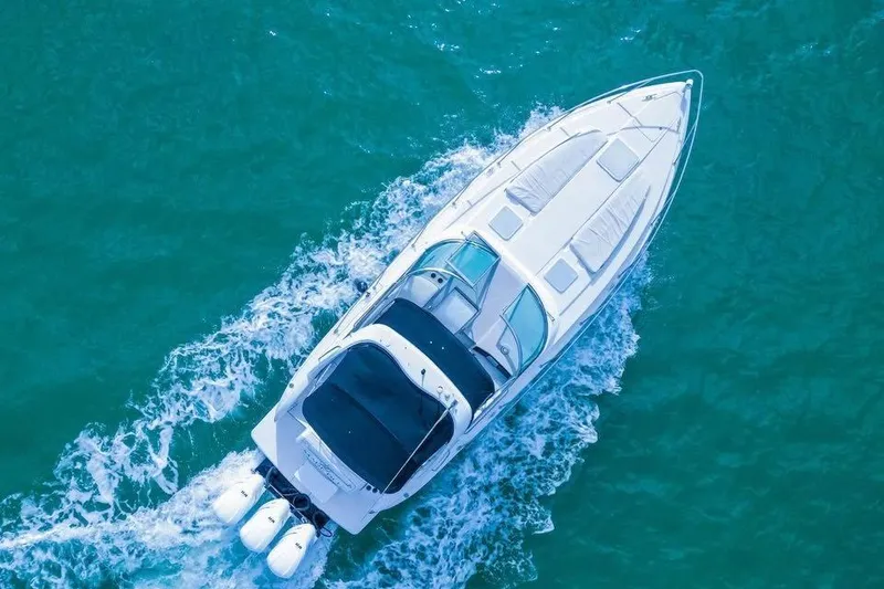 Slide: The Image of 2003 Formula 34 Performance Cruiser navigating turquoise waters, aerial view. - 2