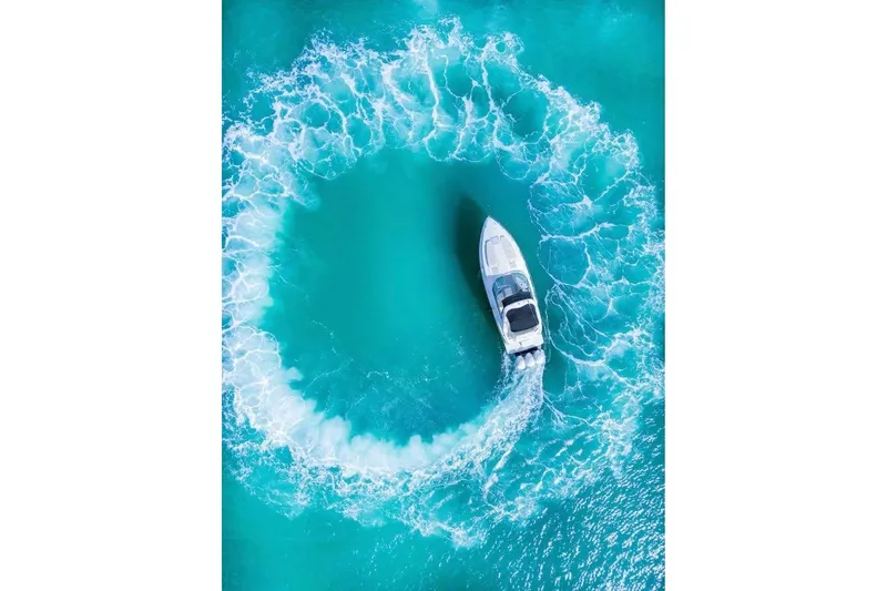Slide: The Image of Aerial view of 2003 Formula 34 Performance Cruiser making circular waves in turquoise water. - 4