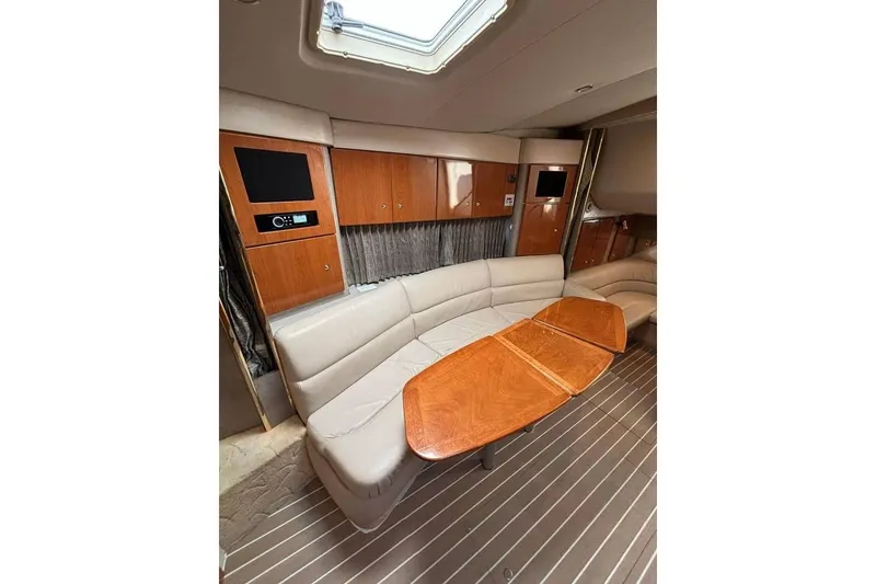 Slide: The Image of 2003 Formula 34 Performance Cruiser interior with leather seating and wooden table. - 7