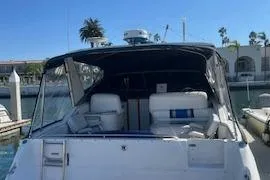 Slide: The Image of 1990 Sea Ray 310 Sundancer docked at marina under clear blue sky. - 5