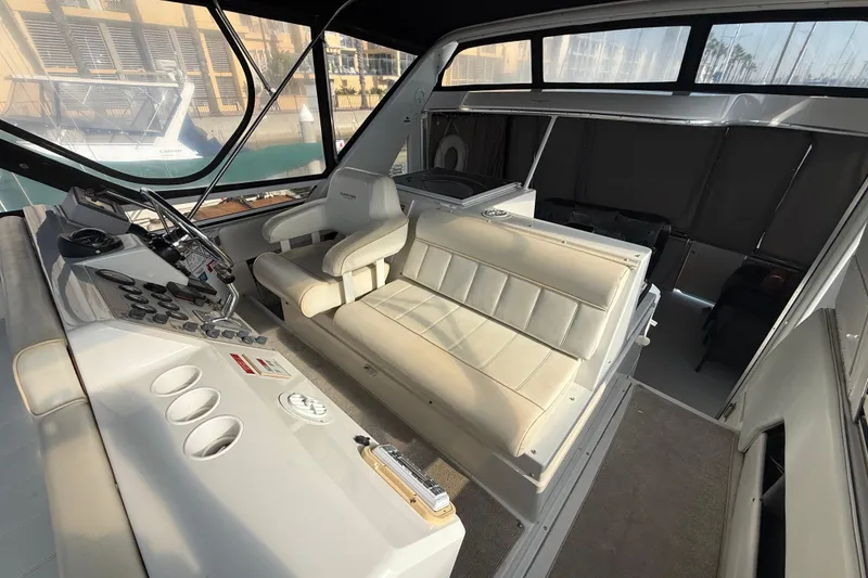 Slide: The Image of 1999 Carver 406 Aft Cabin Motor Yacht interior with helm and seating area. - 10