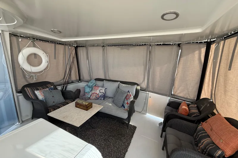 Slide: The Image of 1999 Carver 406 Aft Cabin Motor Yacht interior with cozy seating and nautical decor. - 12