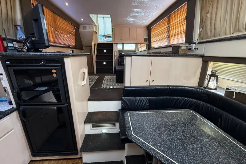 Slide: The Image of Interior of 1999 Carver 406 Aft Cabin Motor Yacht with modern furnishings and cozy seating. - 16