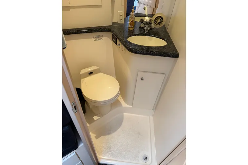 Slide: The Image of Compact bathroom in 1999 Carver 406 Aft Cabin Motor Yacht with toilet and sink. - 21