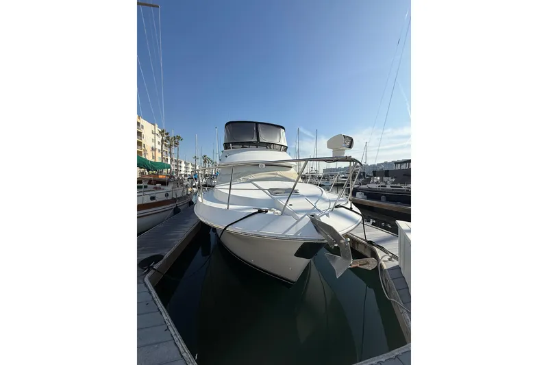Slide: The Image of 1999 Carver 406 Aft Cabin Motor Yacht docked in marina under clear blue sky. - 3