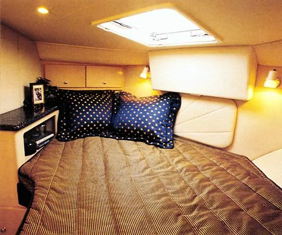 Slide: The Image of 1999 Carver 406 Aft Cabin Motor Yacht interior with modern amenities and marina view. - 6