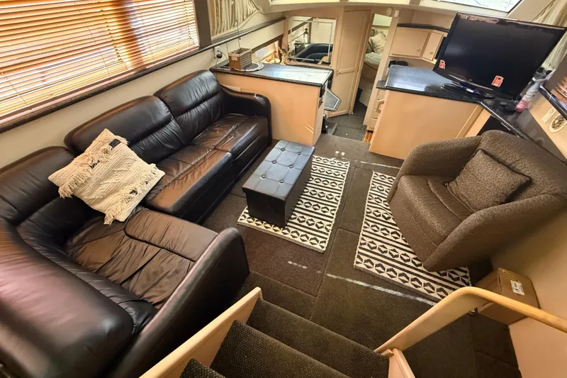 Slide: The Image of Luxurious interior of 1999 Carver 406 Aft Cabin Motor Yacht with leather seating and modern decor. - 13