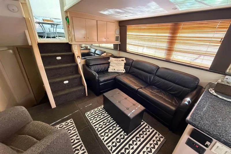 Slide: The Image of Interior of 1999 Carver 406 Aft Cabin Motor Yacht with leather seating and modern decor. - 15