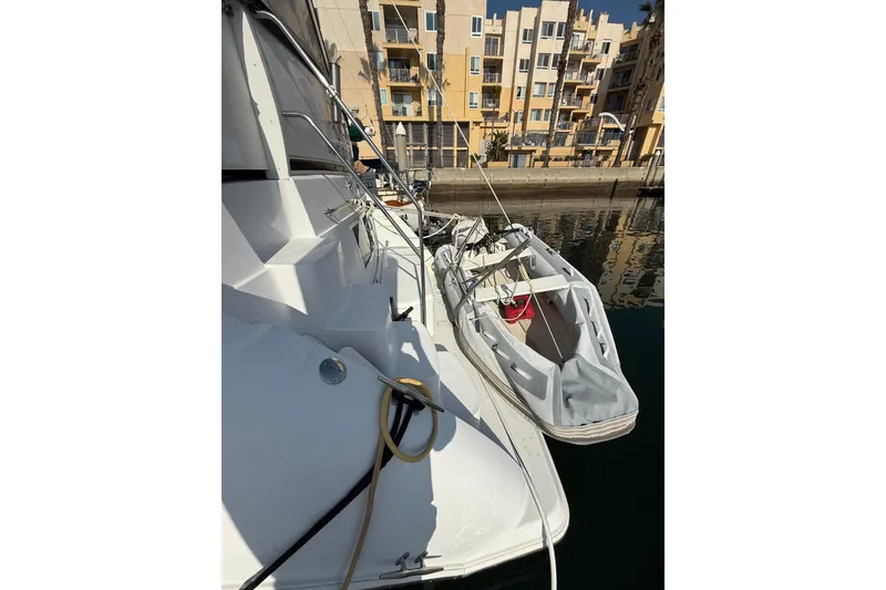 Slide: The Image of 1999 Carver 406 Aft Cabin Motor Yacht docked with inflatable boat nearby. - 32