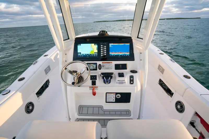 Slide: The Image of 2025 Sea Fox 268 Commander boat cockpit with advanced navigation system on open water. - 13
