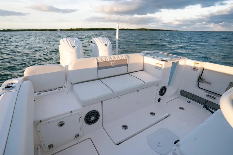 Slide: The Image of 2025 Sea Fox 268 Commander boat interior with seating, ocean view, and dual engines. - 20