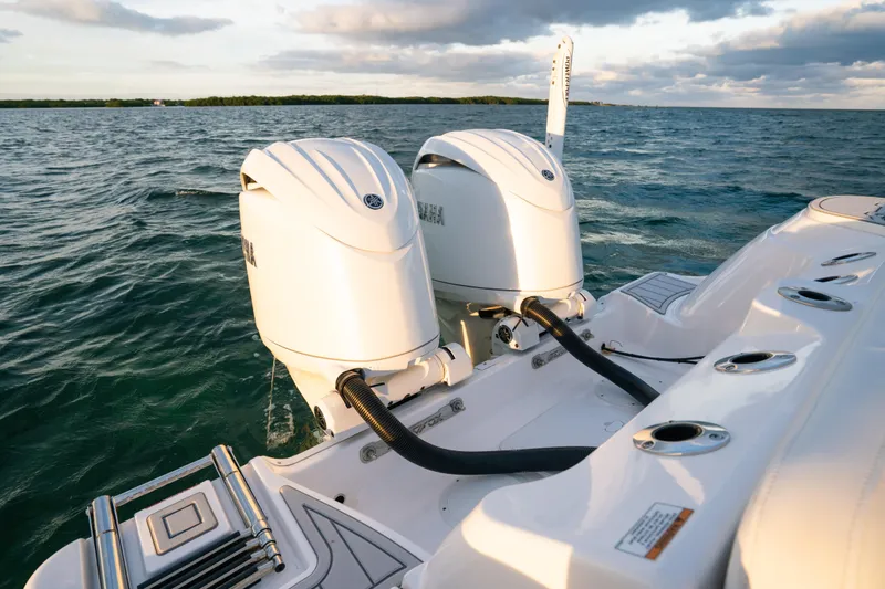 Slide: The Image of 2025 Sea Fox 268 Commander boat with dual outboard engines on open water. - 22