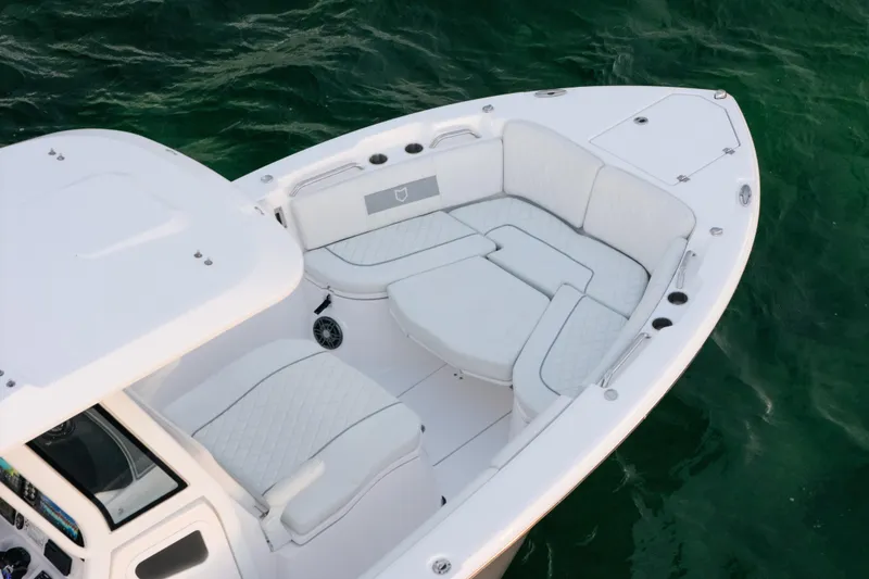 Slide: The Image of 2025 Sea Fox 268 Commander boat with spacious seating on calm green water. - 6