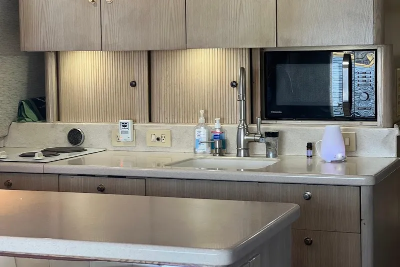 Slide: The Image of Luxurious interior of 1996 Ocean Yachts 48 Super Sport with modern amenities and seating. - 12