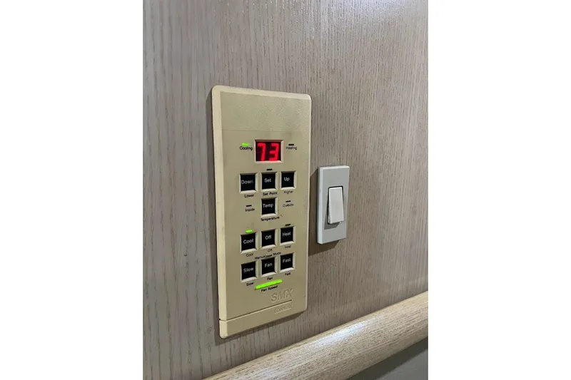 Slide: The Image of Interior of 1996 Ocean Yachts 48 Super Sport, featuring a modern kitchen with wood flooring. - 16