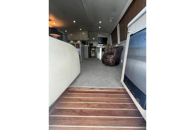 Slide: The Image of Interior of 1996 Ocean Yachts 48 Super Sport with wooden flooring and modern cabinetry. - 18